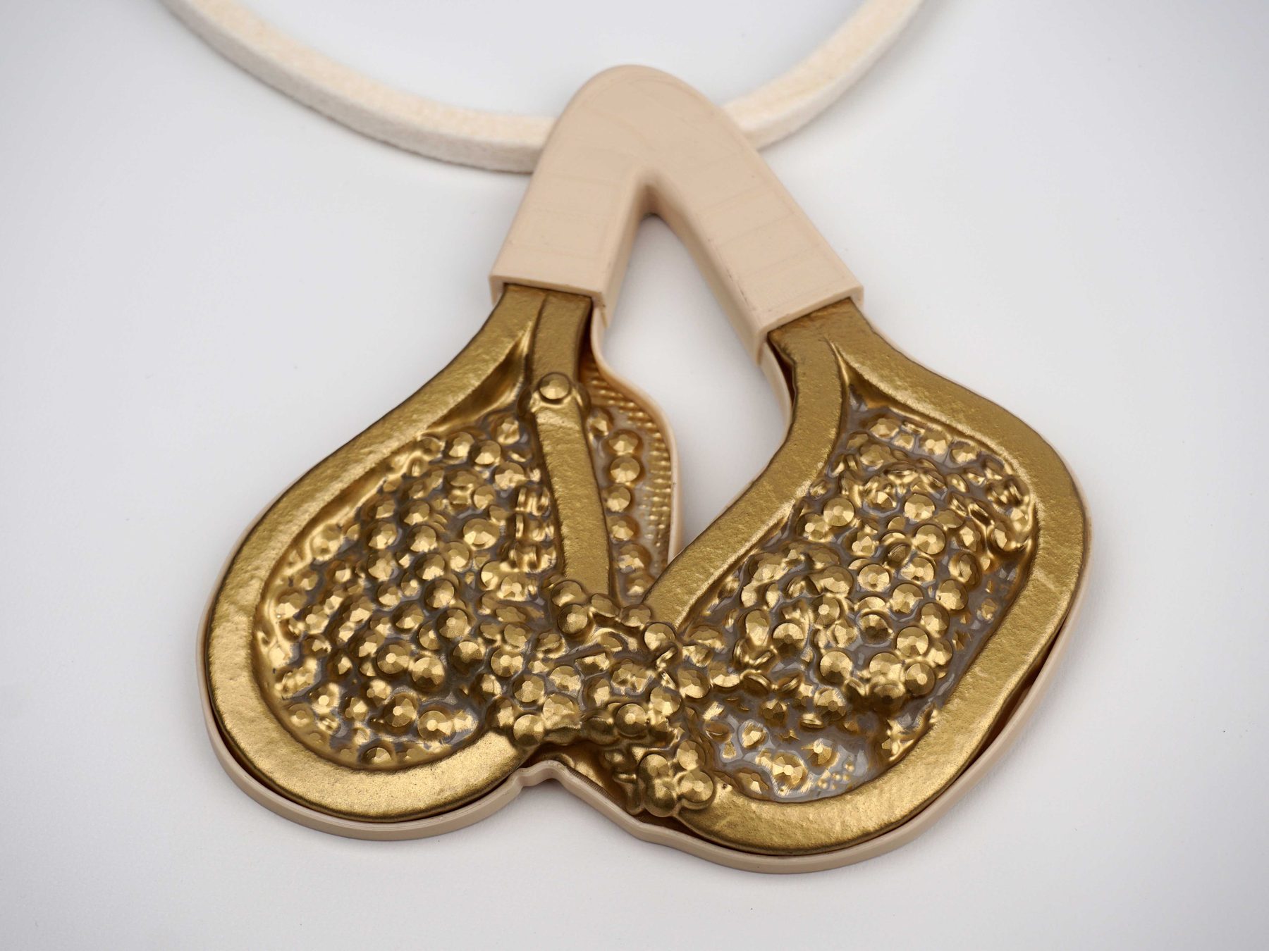 Gold colored neckpiece.