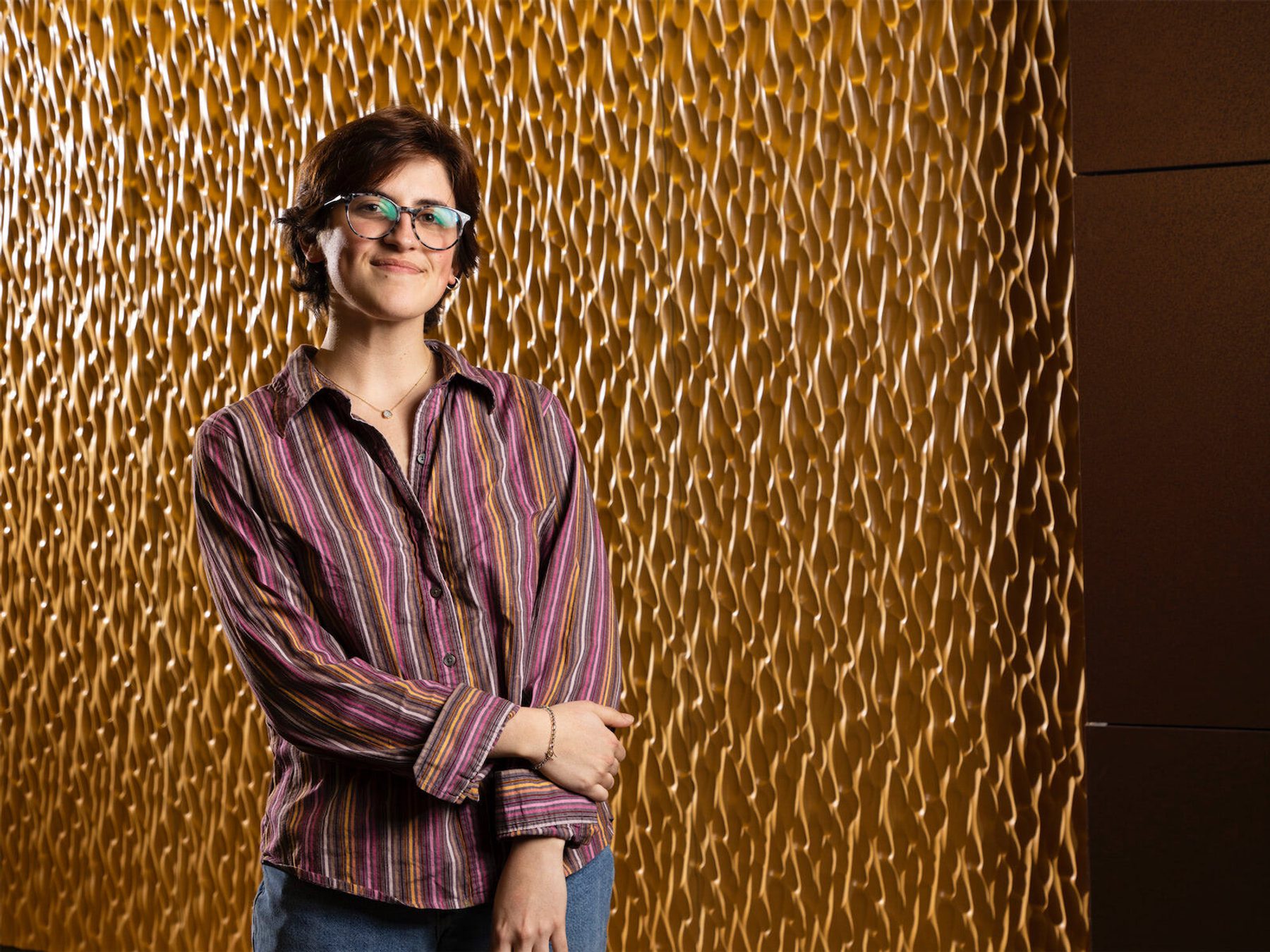 Georgie Correa, wearing a striped shirt and glasses