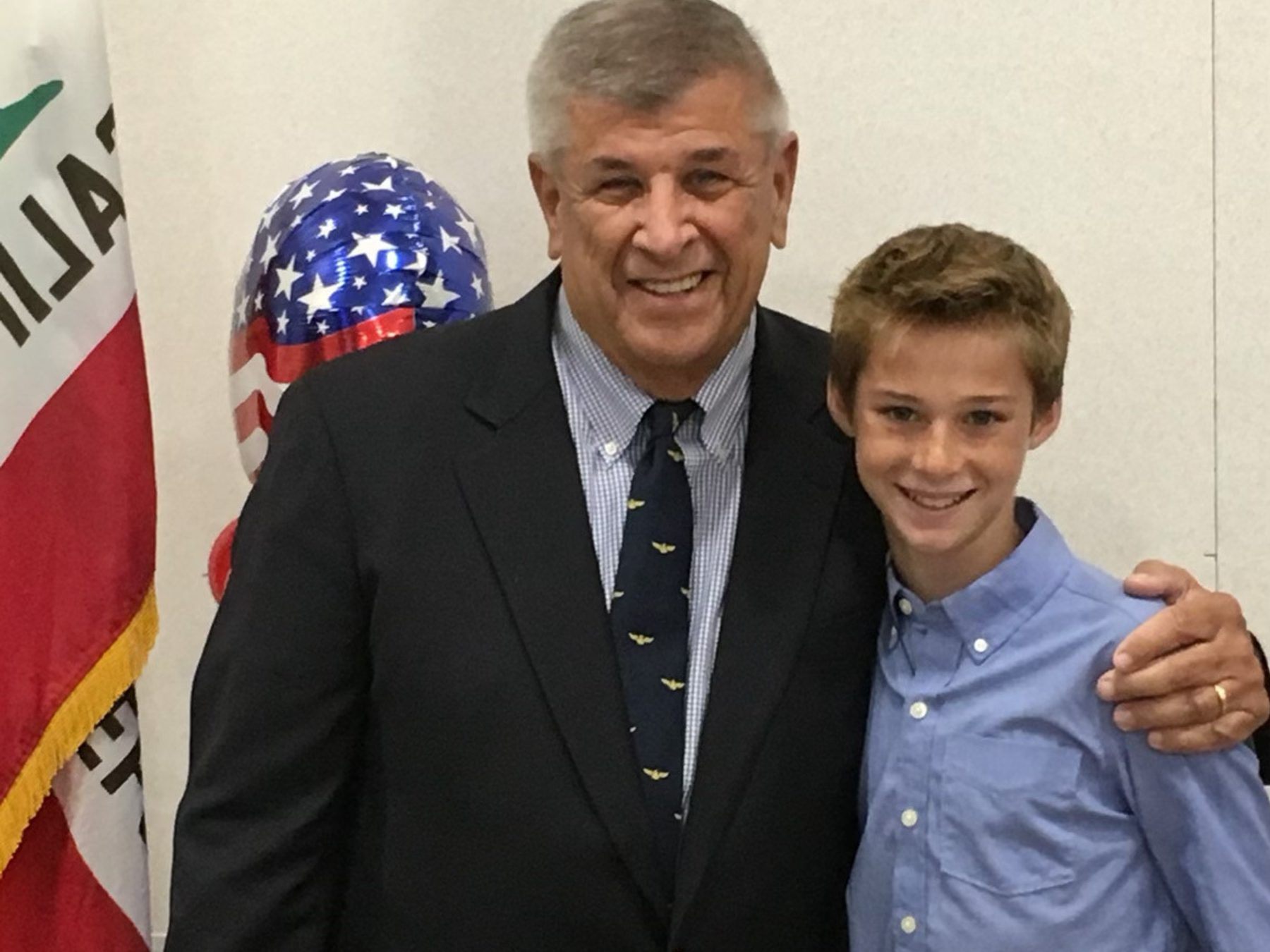 Young Jake Schraga poses with his Poppy, wearing a suit and tie.
