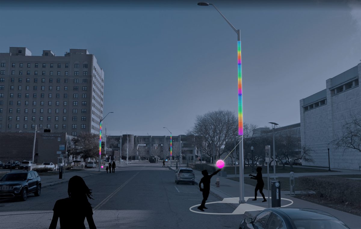 A lamppost covered in rainbow stripes of LED lights, with a tetherball attached to the top.