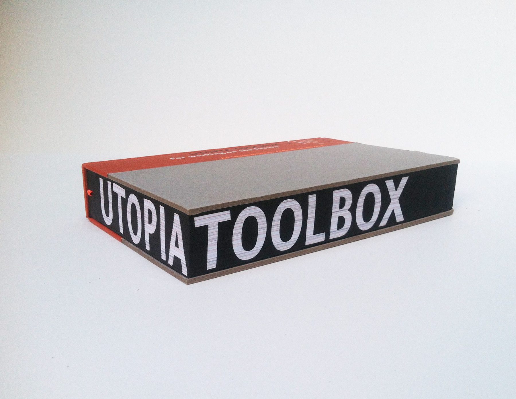 Image of a book, with the words UTOPIA TOOLBOK on the page edges